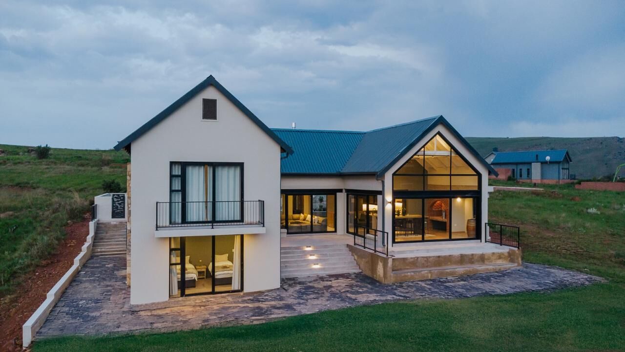 Gable Vista at dusk, its glass gable lit from inside